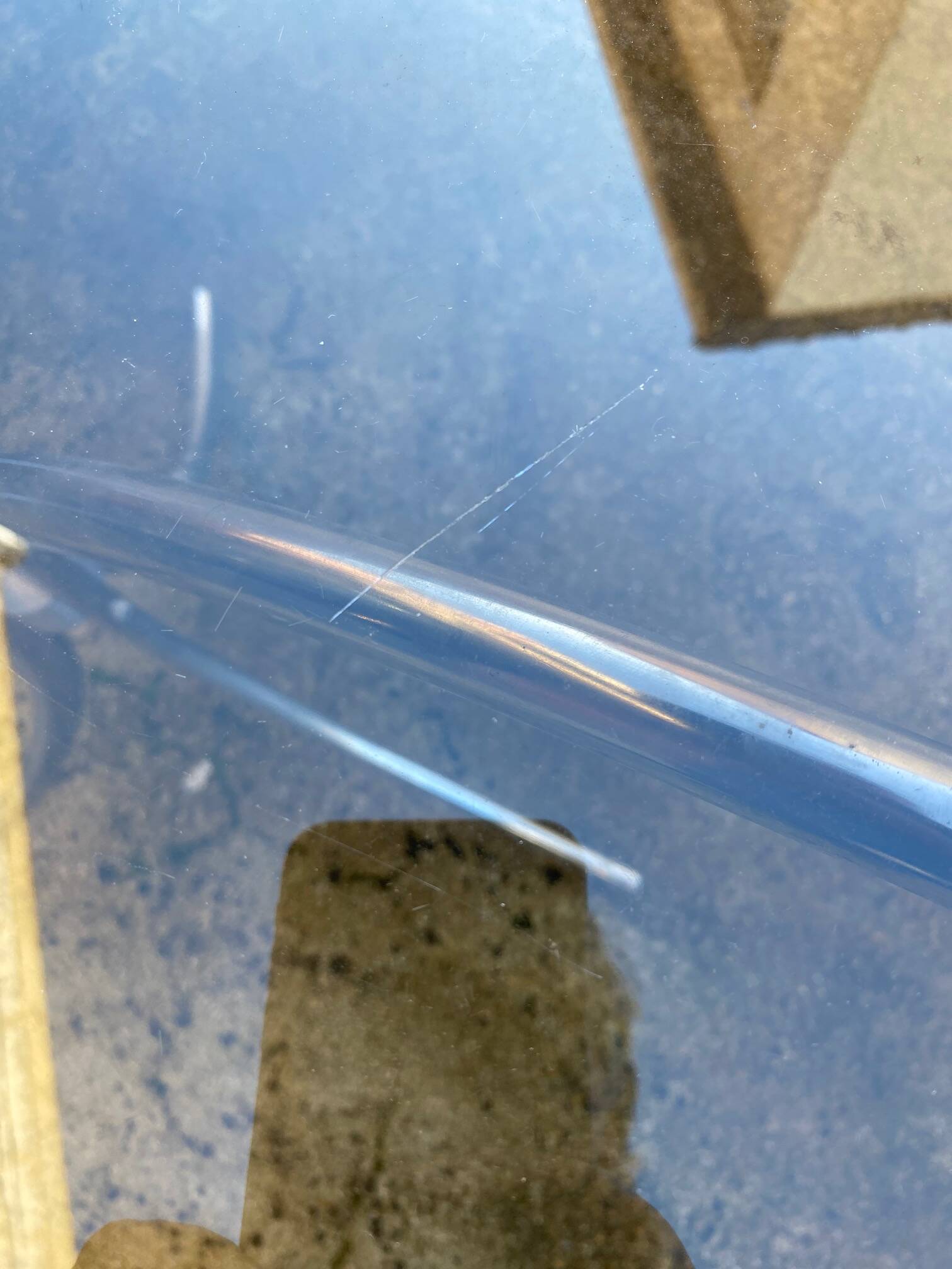 Table with chrome metal legs and smoked glass top.