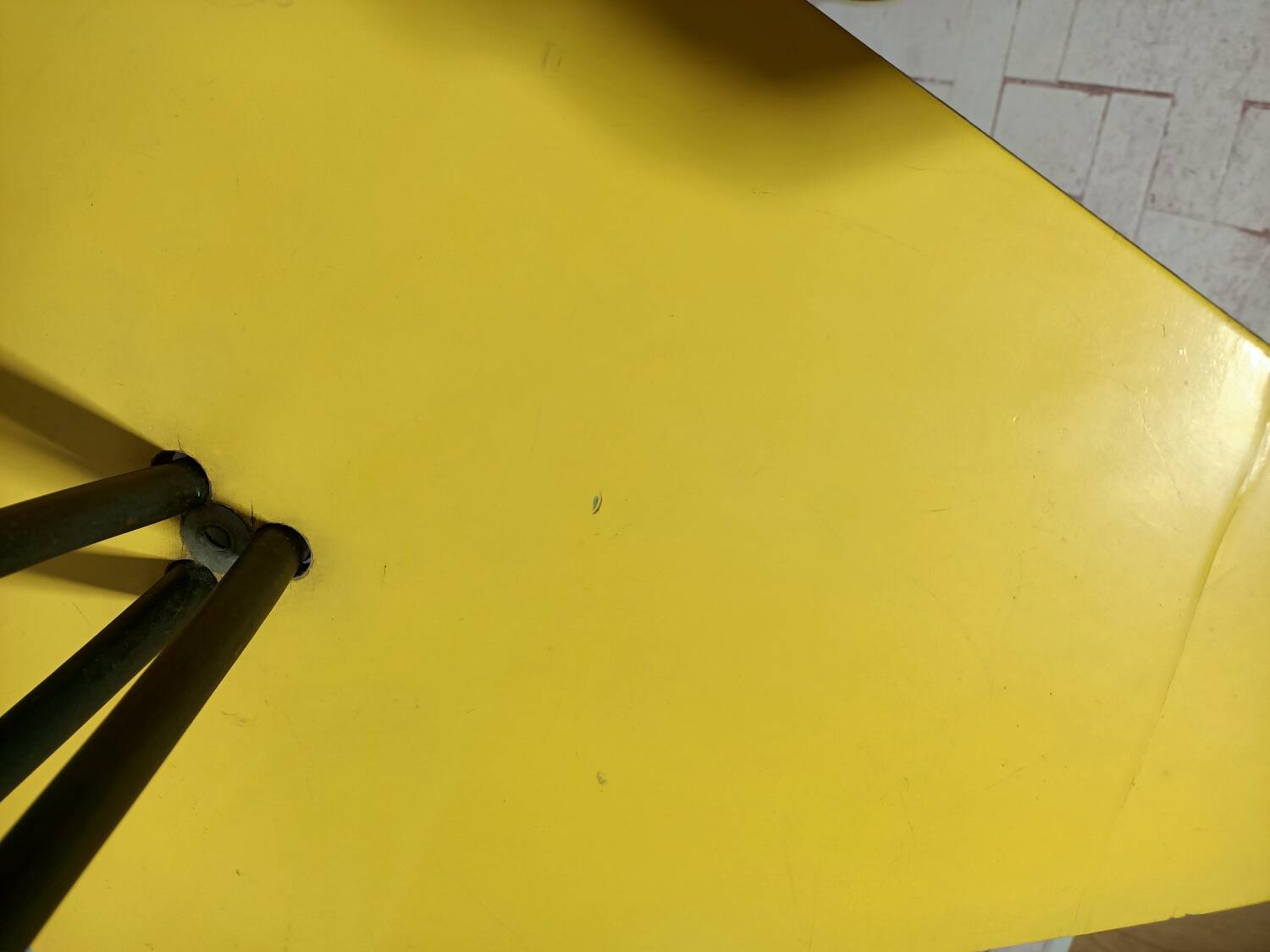 Mid-century tripod floor lamp with 3 lights and a yellow shelf.