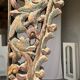 Indonesian construction element in carved wood with intertwined plant motifs mounted on a base (fri