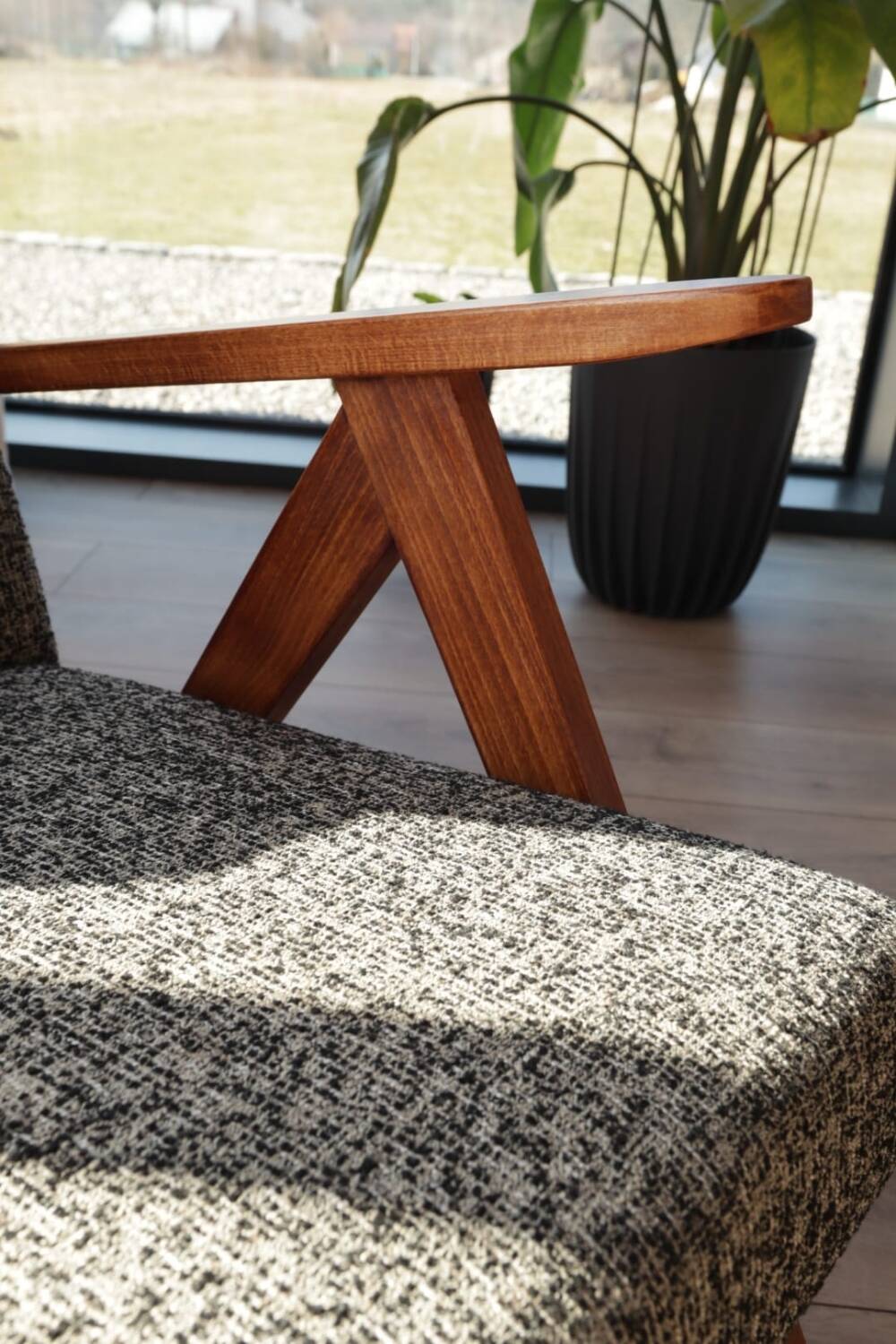 Vintage design armchair in mixed black fabric, walnut-coloured wood.