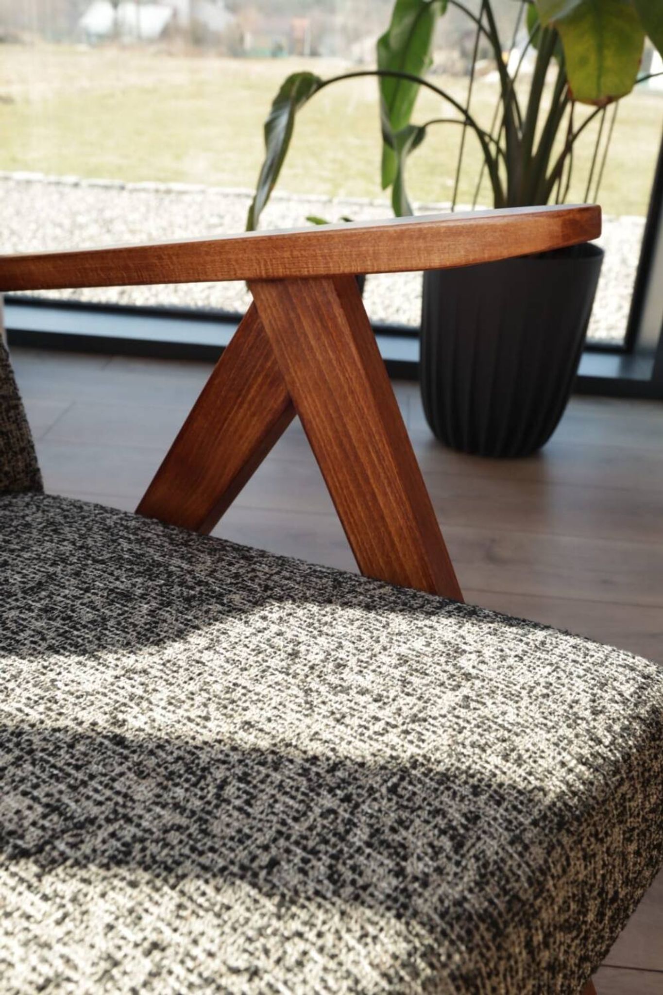 Vintage design armchair in mixed black fabric, walnut-coloured wood.