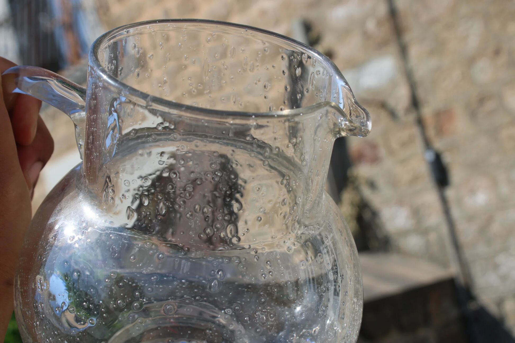 Vintage blown glass pitcher with bubbles, transparent.