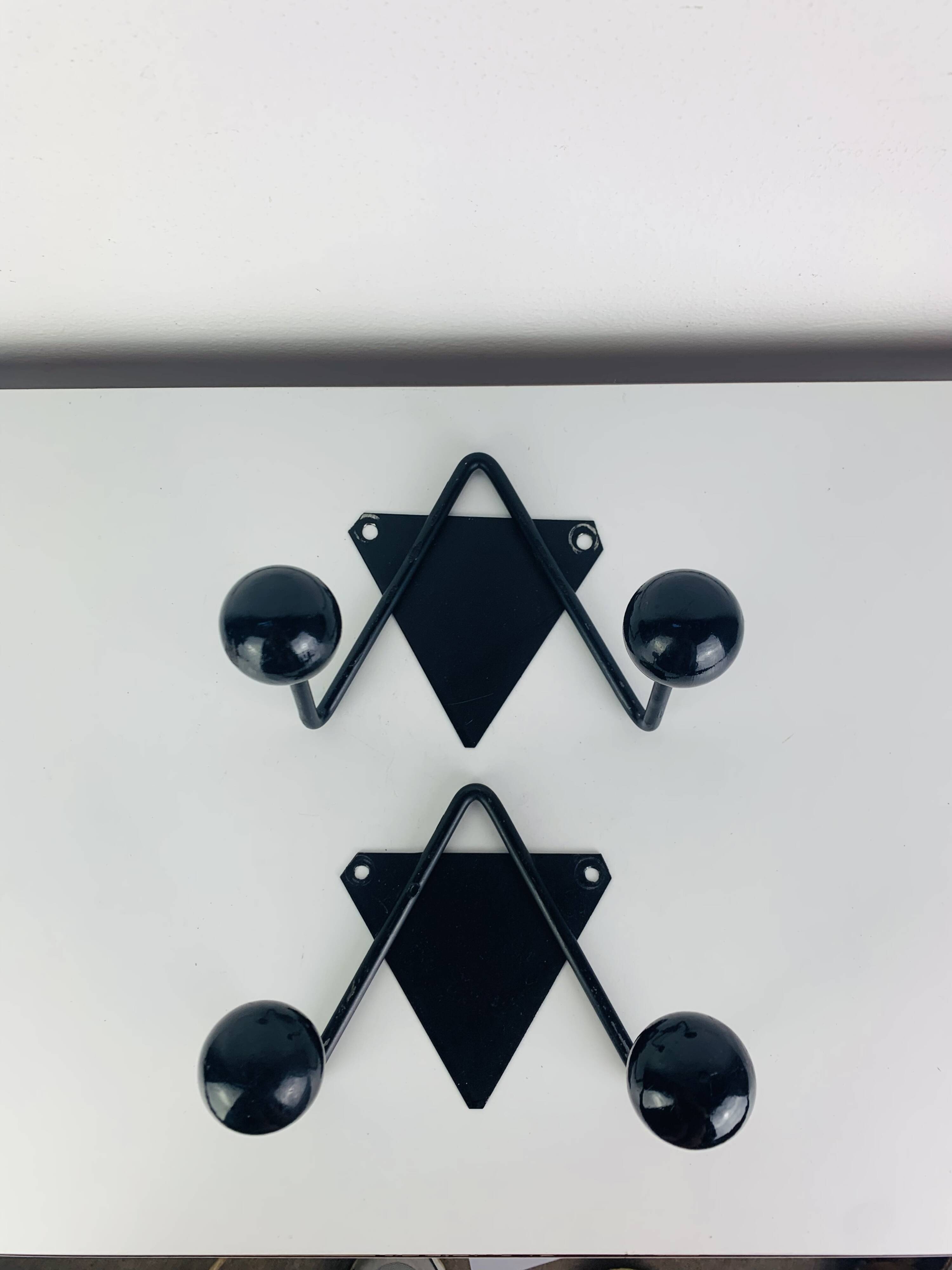 Pair of wall hooks from the 1950s, black metal