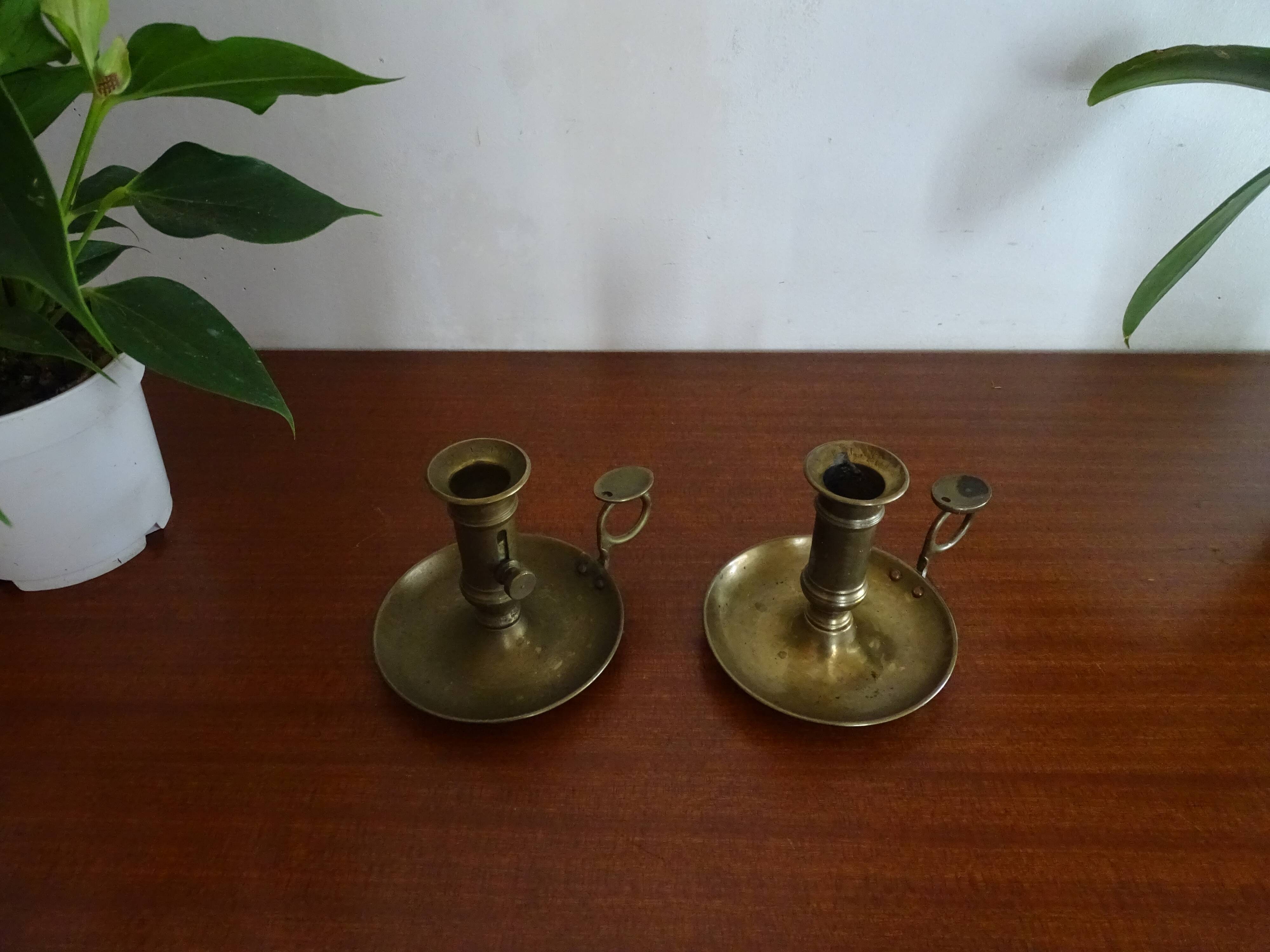 Pair of vintage brass pusher candle holders