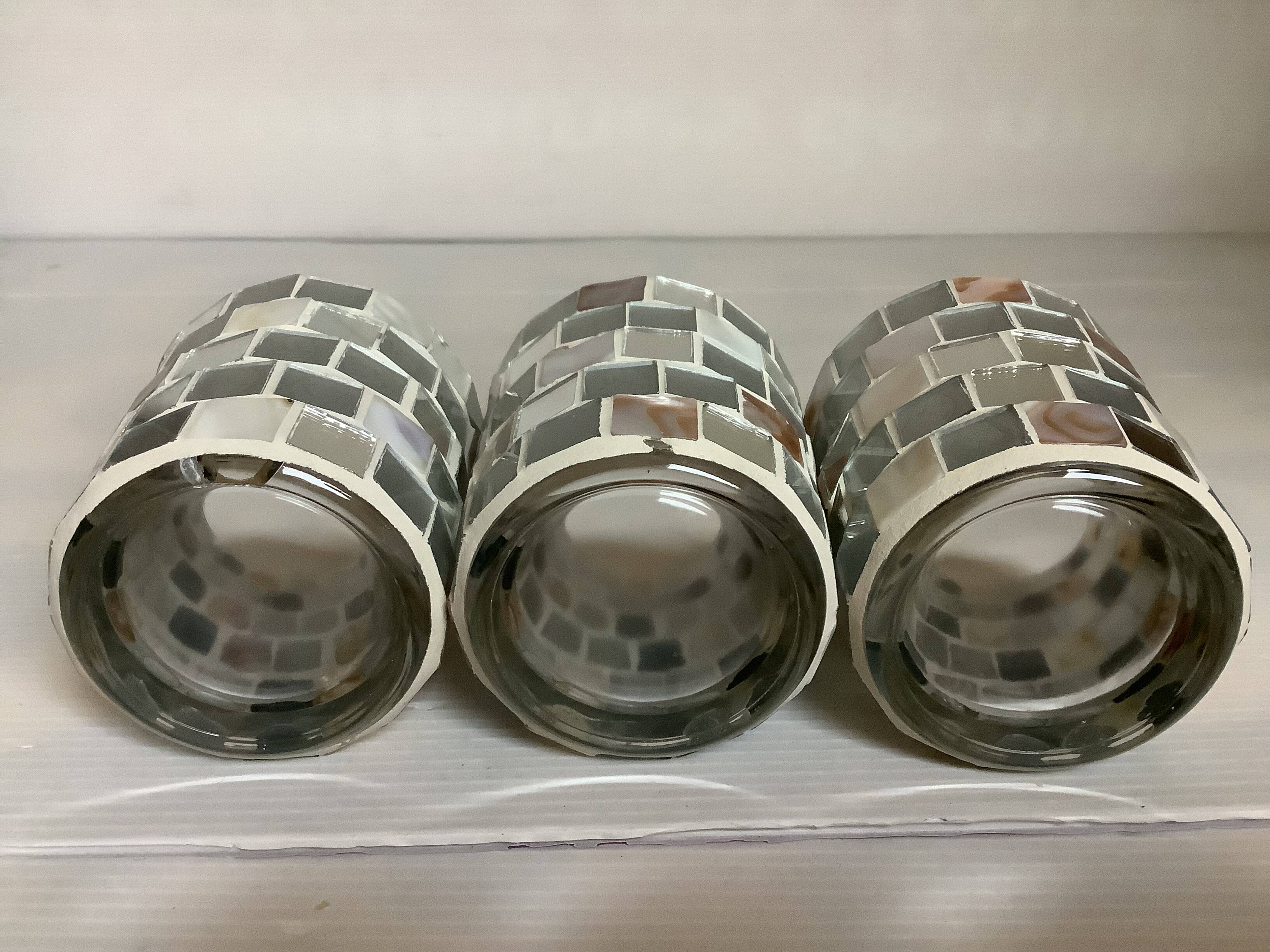 Four mosaic mirror and mother-of-pearl candle holders.