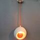 White openwork pendant light with orange interior 1970/1980.