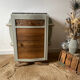 Pair of mismatched art deco bedside tables in green and wood
