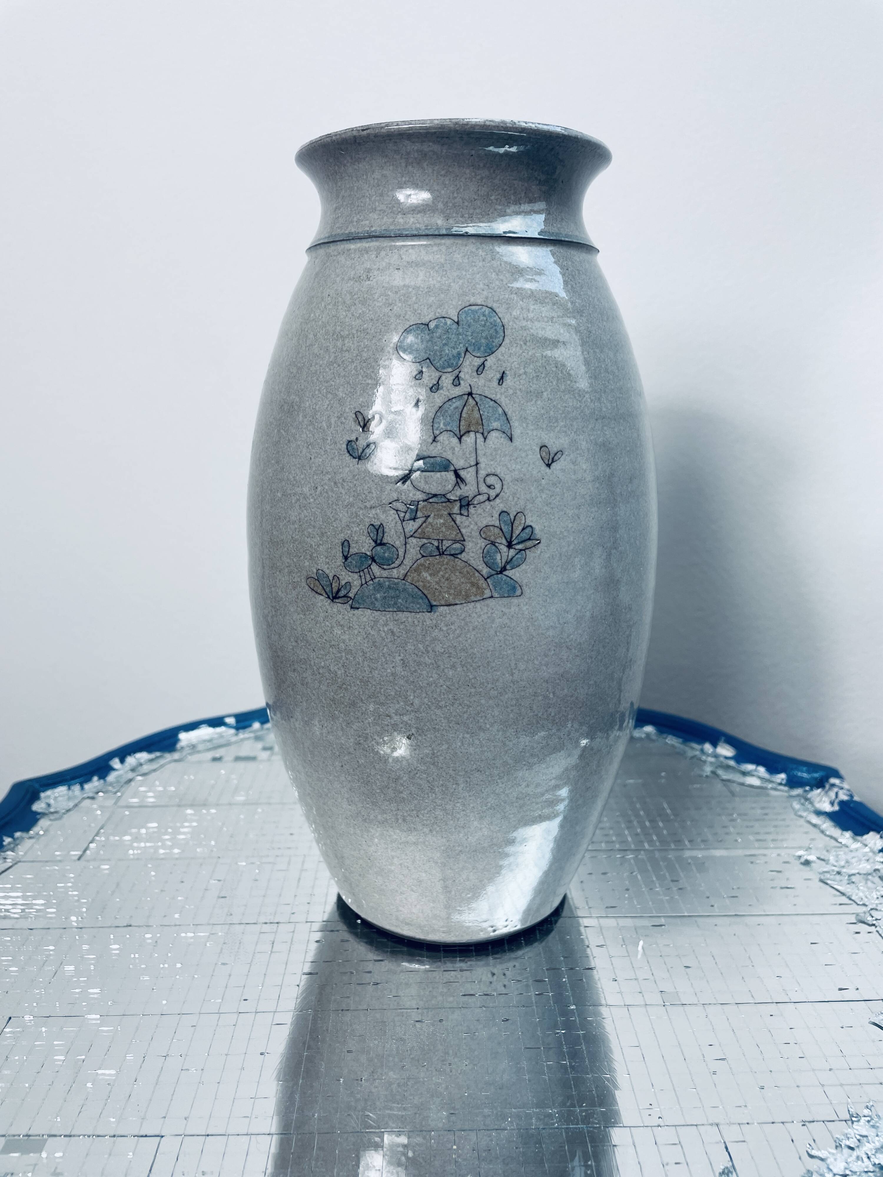 Handcrafted gray stoneware vase with child illustration