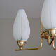 Brass chandelier and tulips in vintage white glass