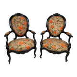 Pair of Napoleon III armchairs, in blackened wood, floral patterned fabric