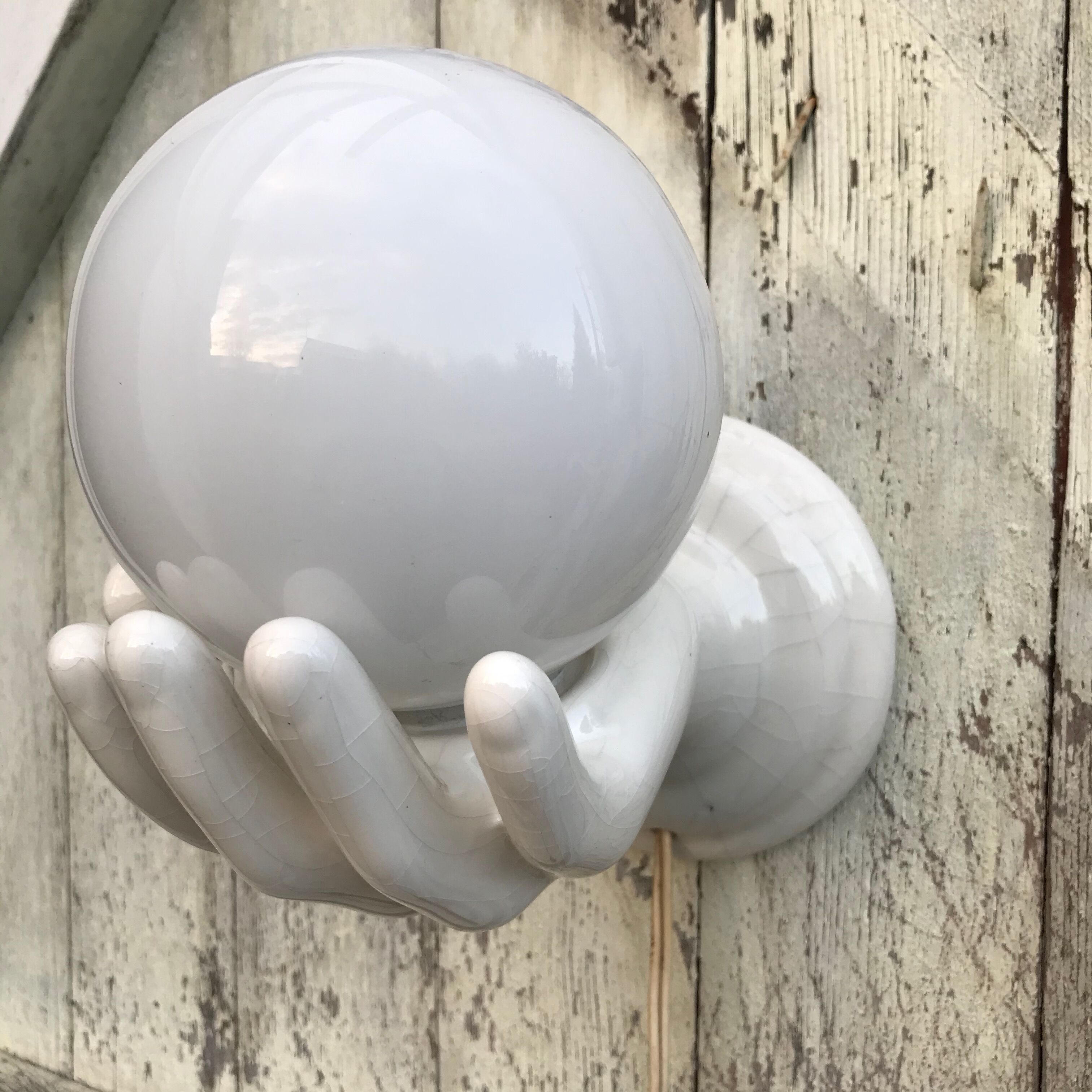 Hand-shaped ceramic wall light