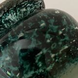 Glass bottle with silver glitter inclusions