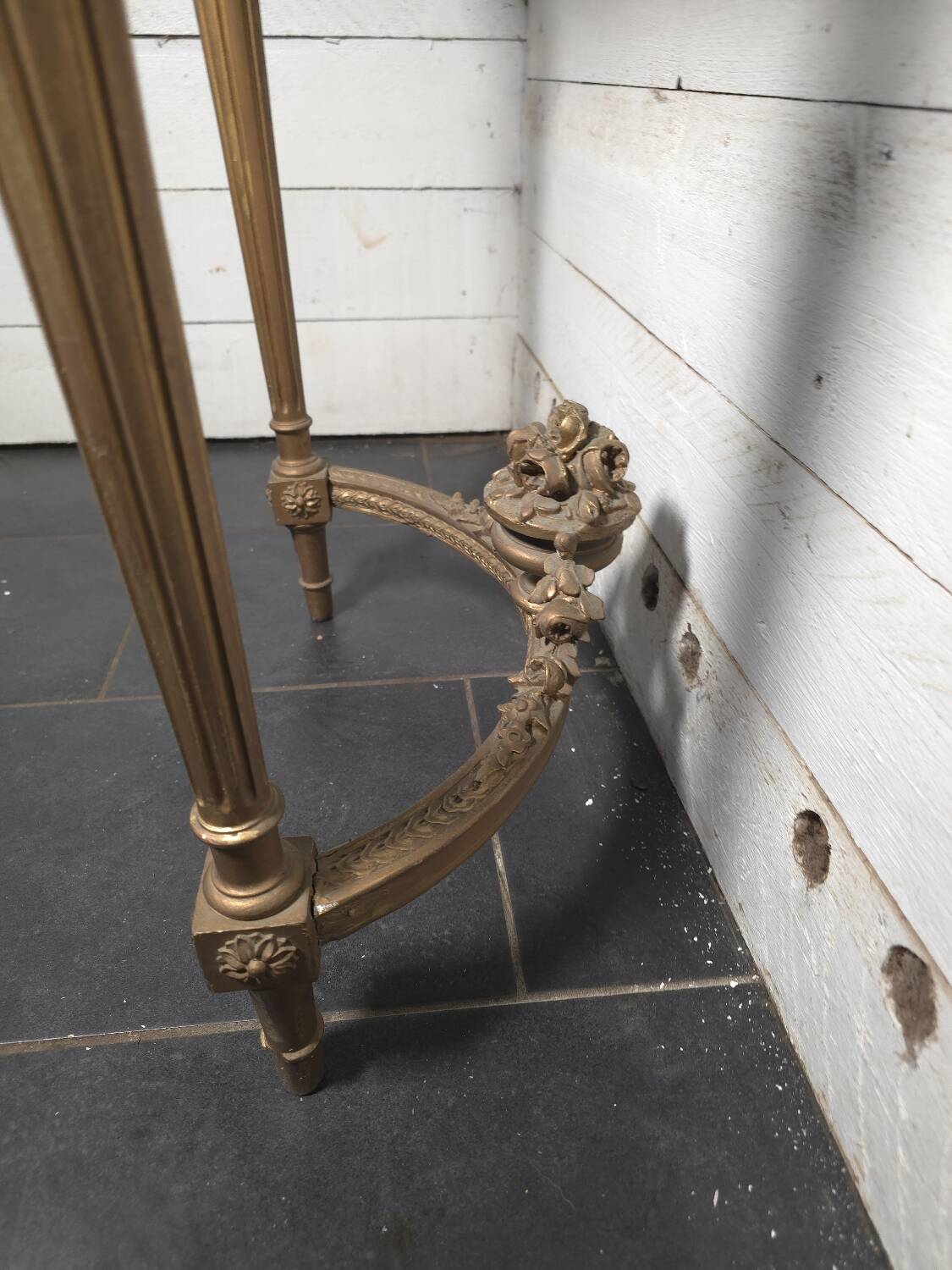 Louis XVI style console in gilded wood with a marble top.