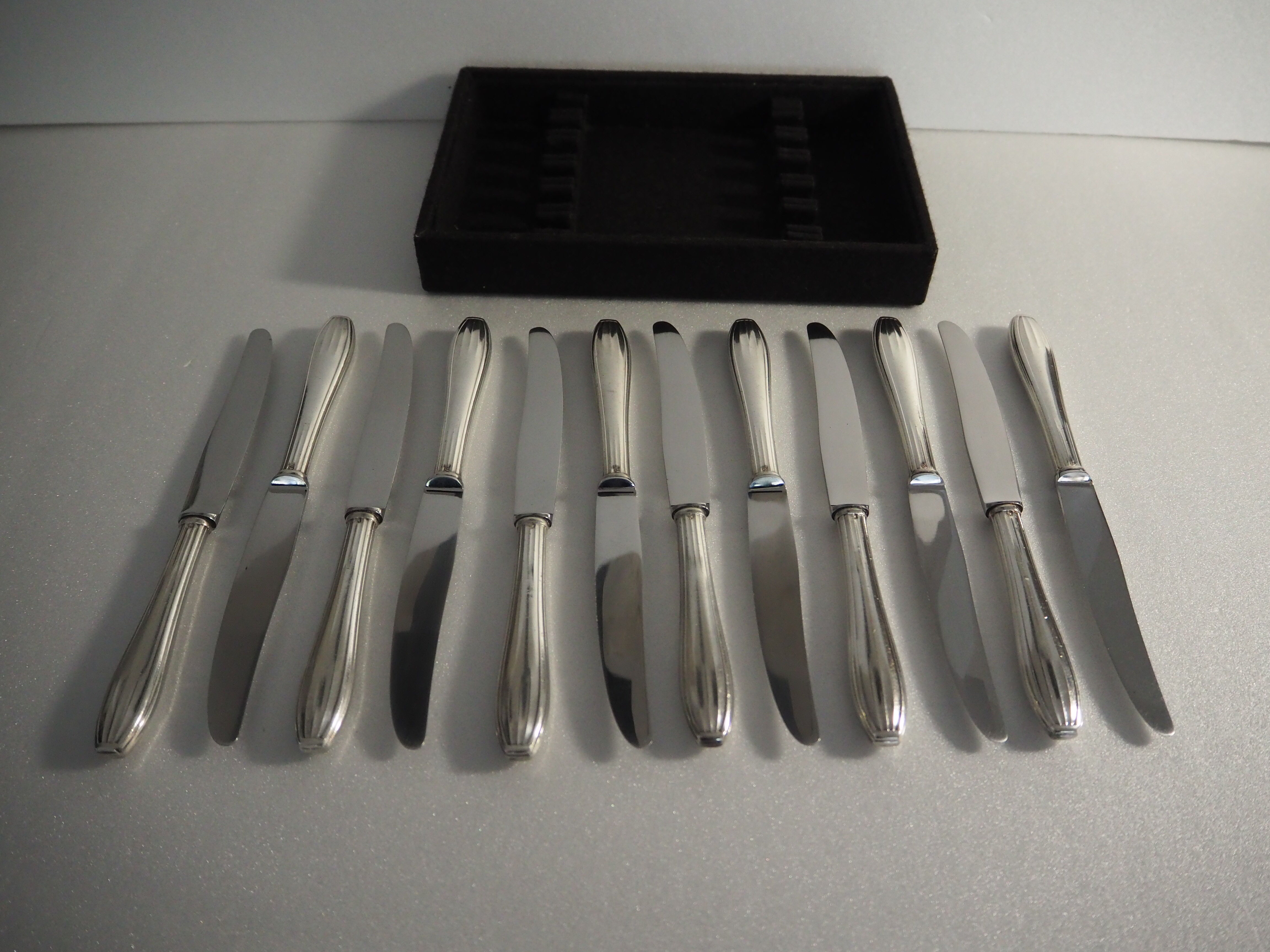 12 SFAM cheese knives in its dark chocolate case