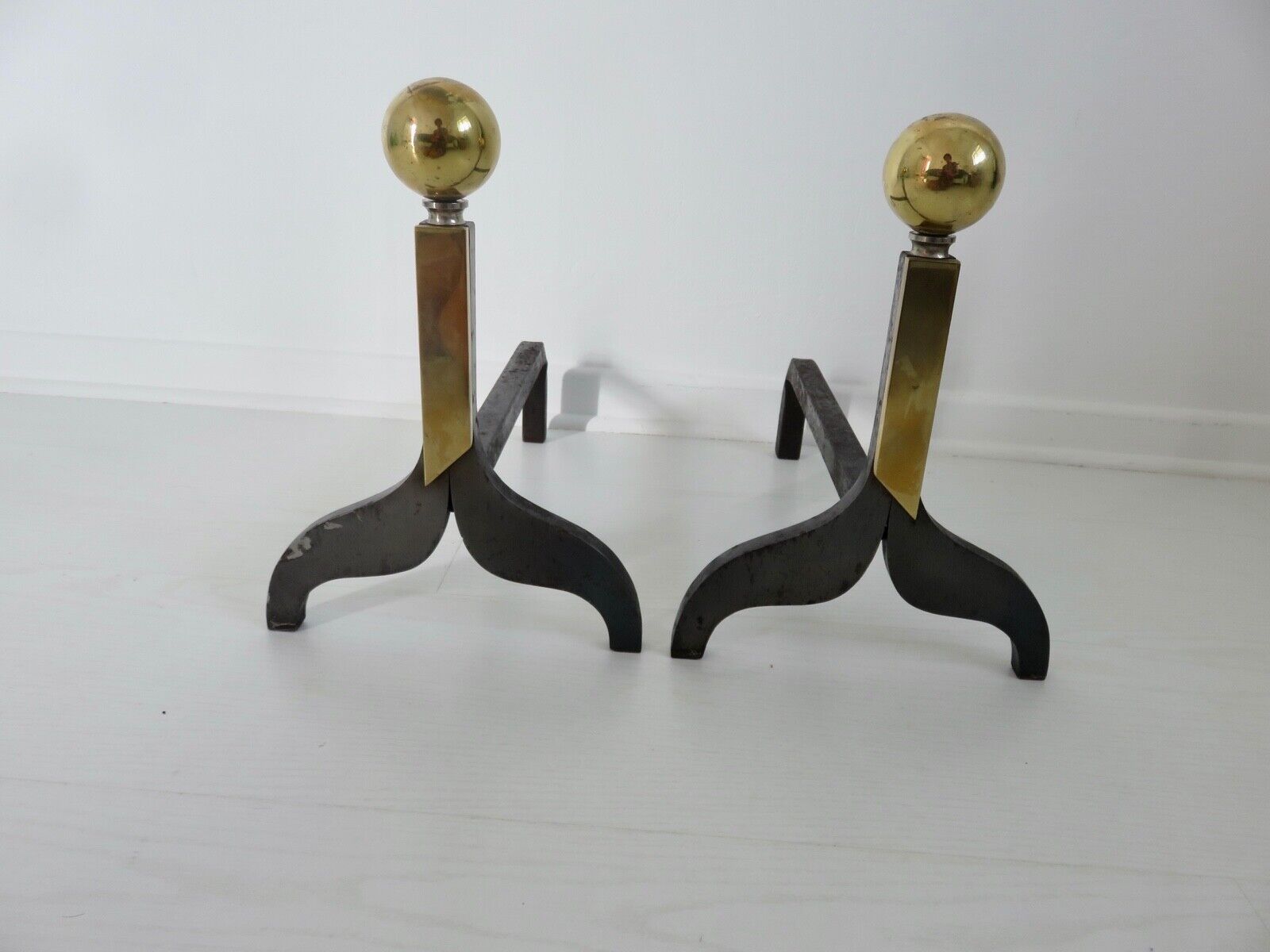 Pair of modernist steel and brass andirons