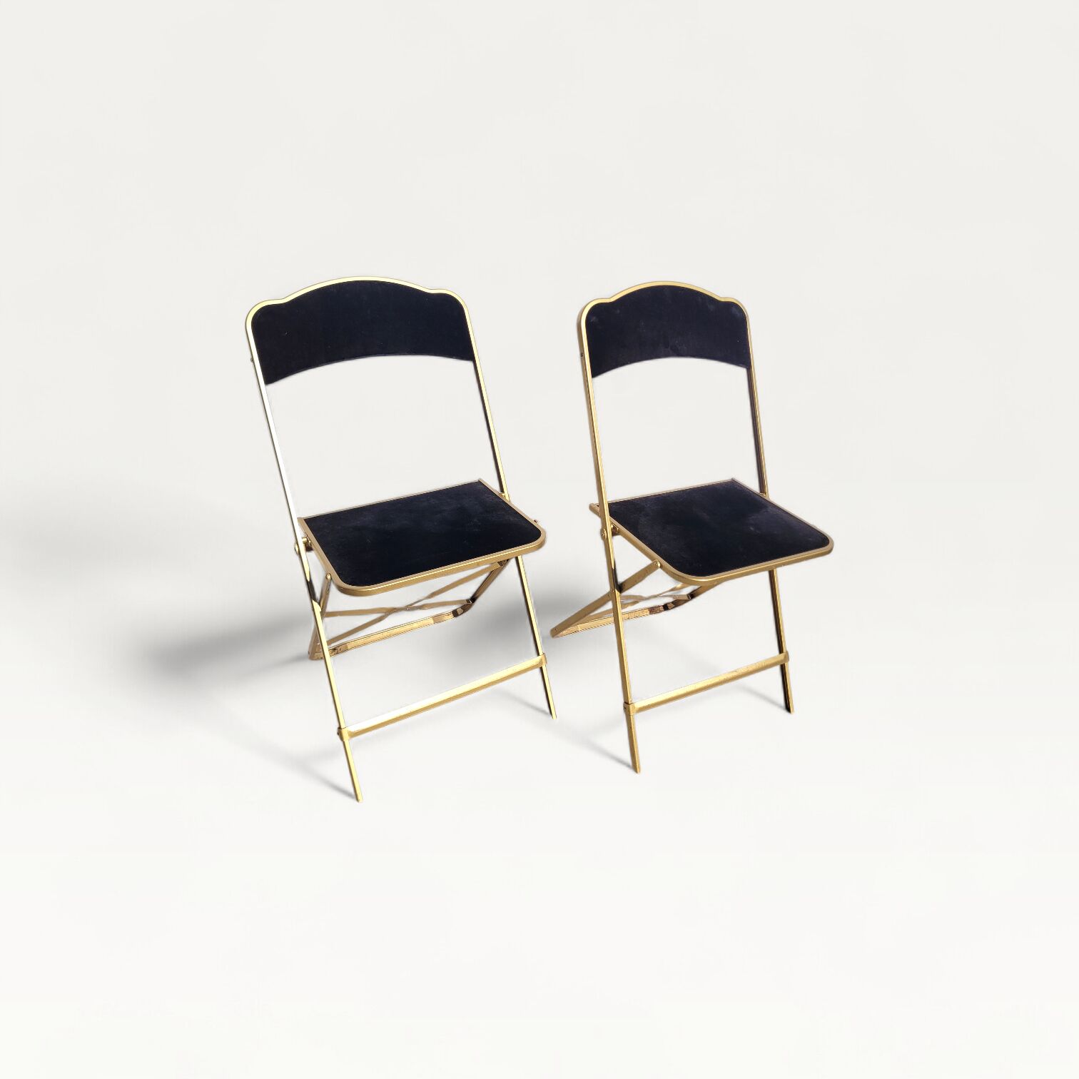 Pair of black and gold folding opera chairs