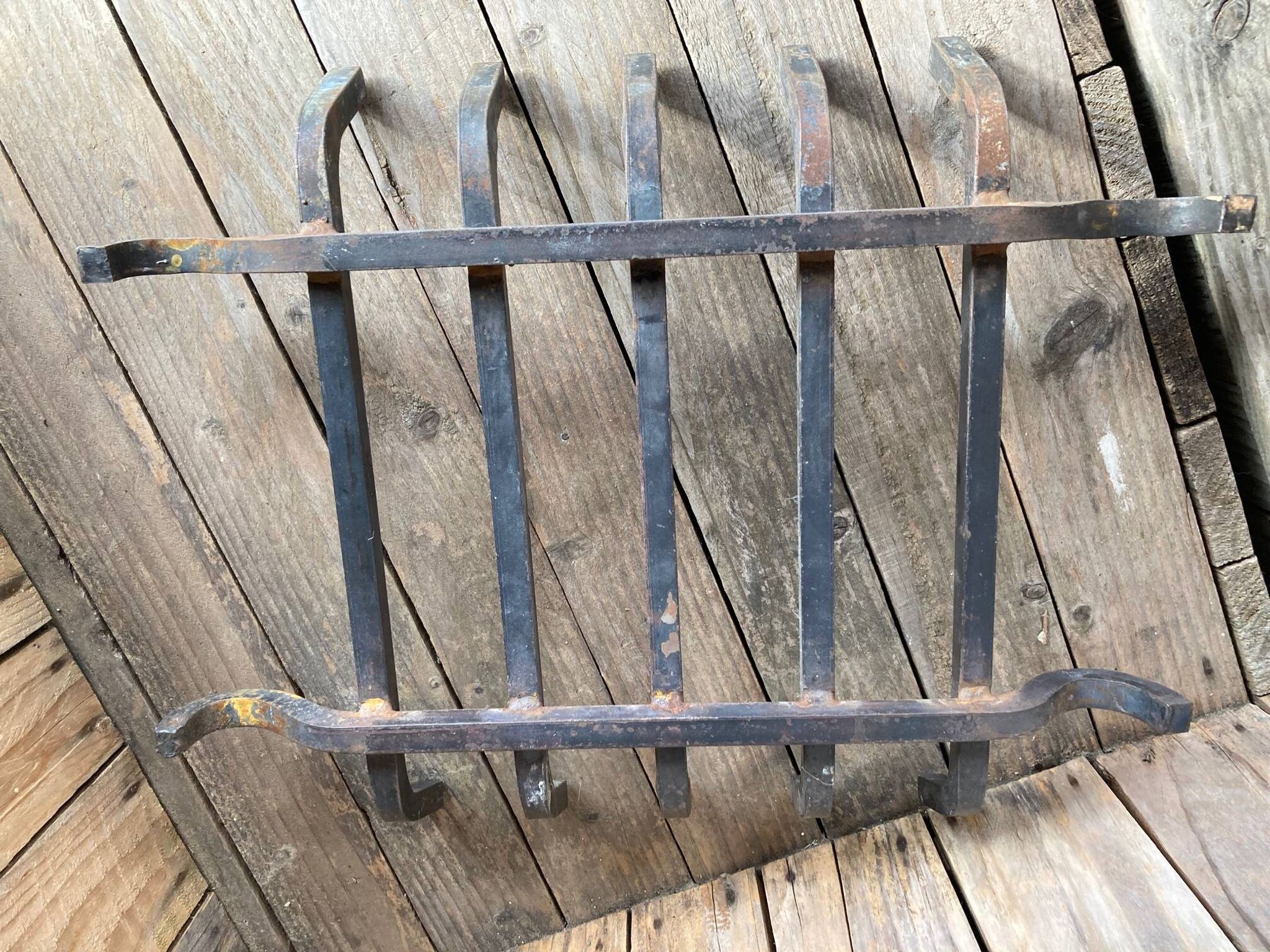 Pair of andirons and grates in cast iron and bronze with gilded grotesques, 17th century