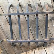 Pair of andirons and grates in cast iron and bronze with gilded grotesques, 17th century