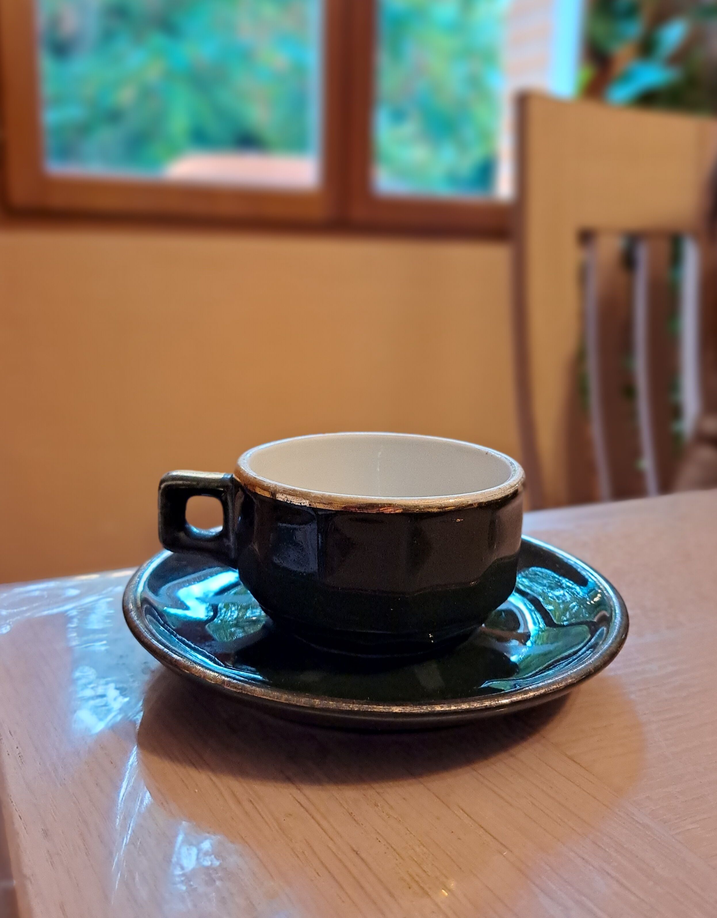 Green and gold coffee cups and sub-cups