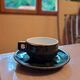 Green and gold coffee cups and sub-cups