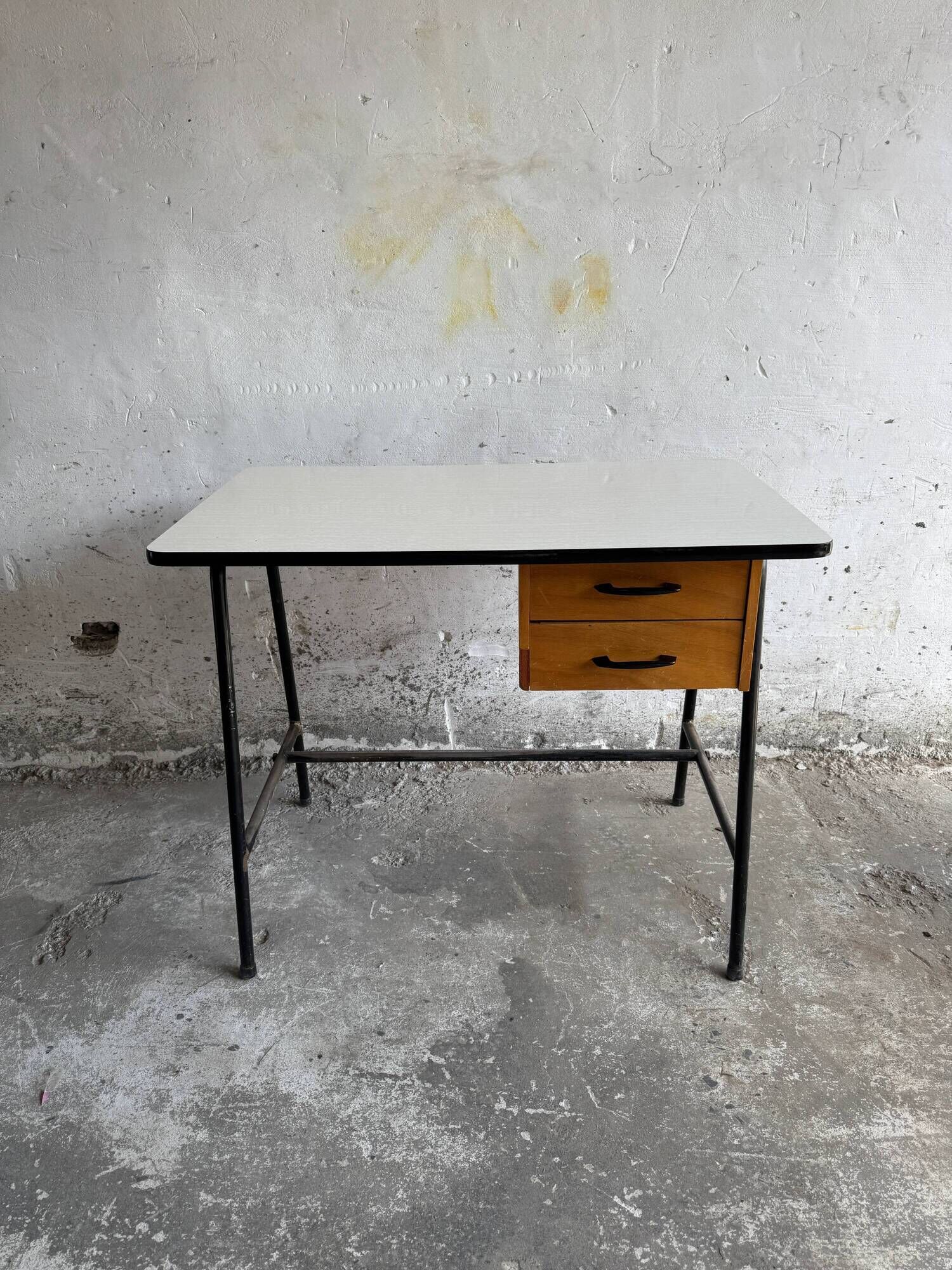 Black metal and wood mid-century industrial desk with laminated top and two drawers