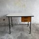 Black metal and wood mid-century industrial desk with laminated top and two drawers