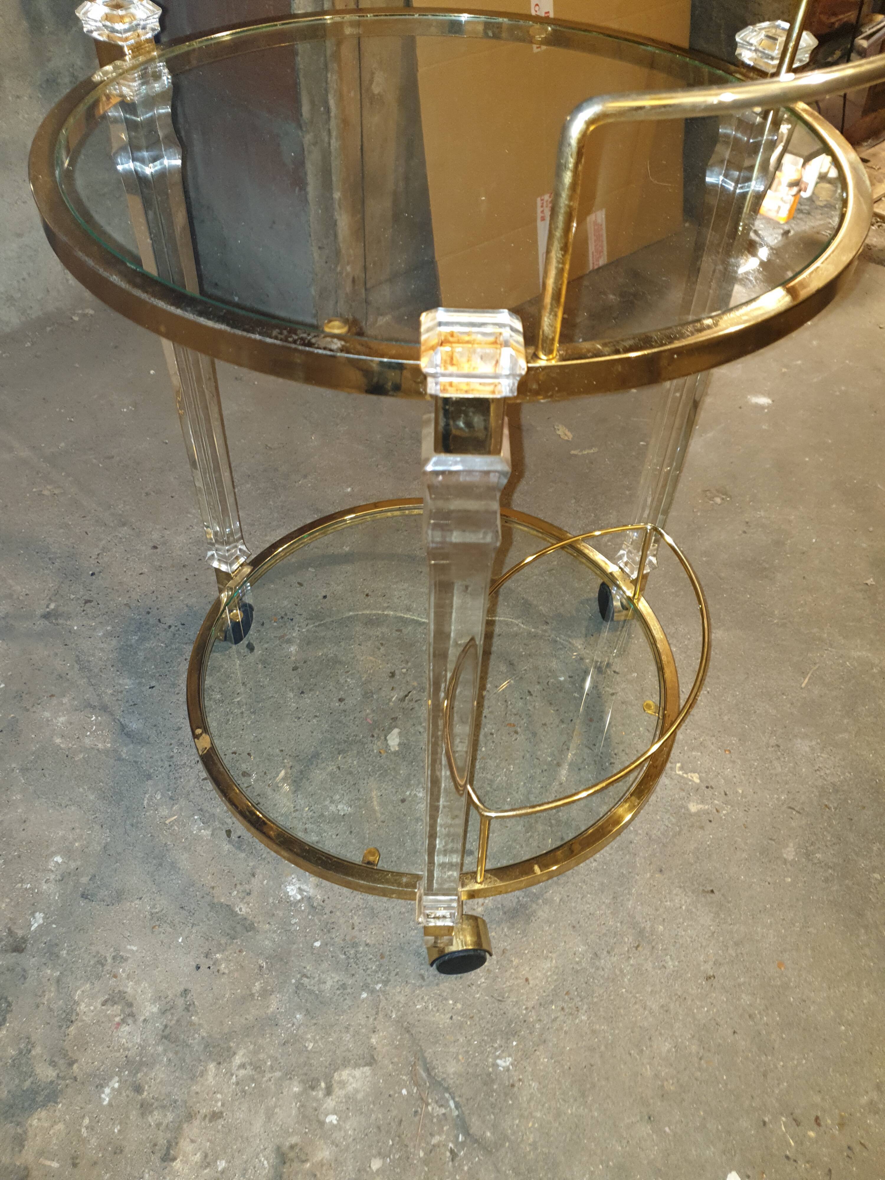 Round table in glass and brass and acrylic columns, 1980