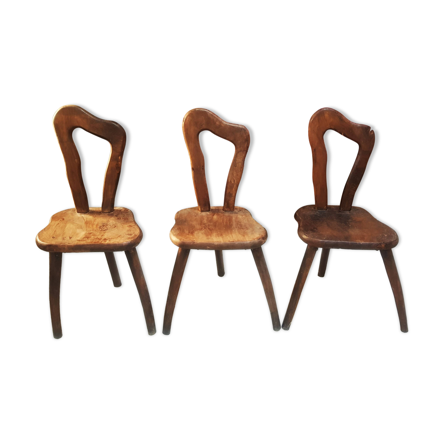 3 brutalist wooden tripod chairs