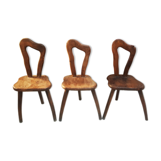 3 brutalist wooden tripod chairs
