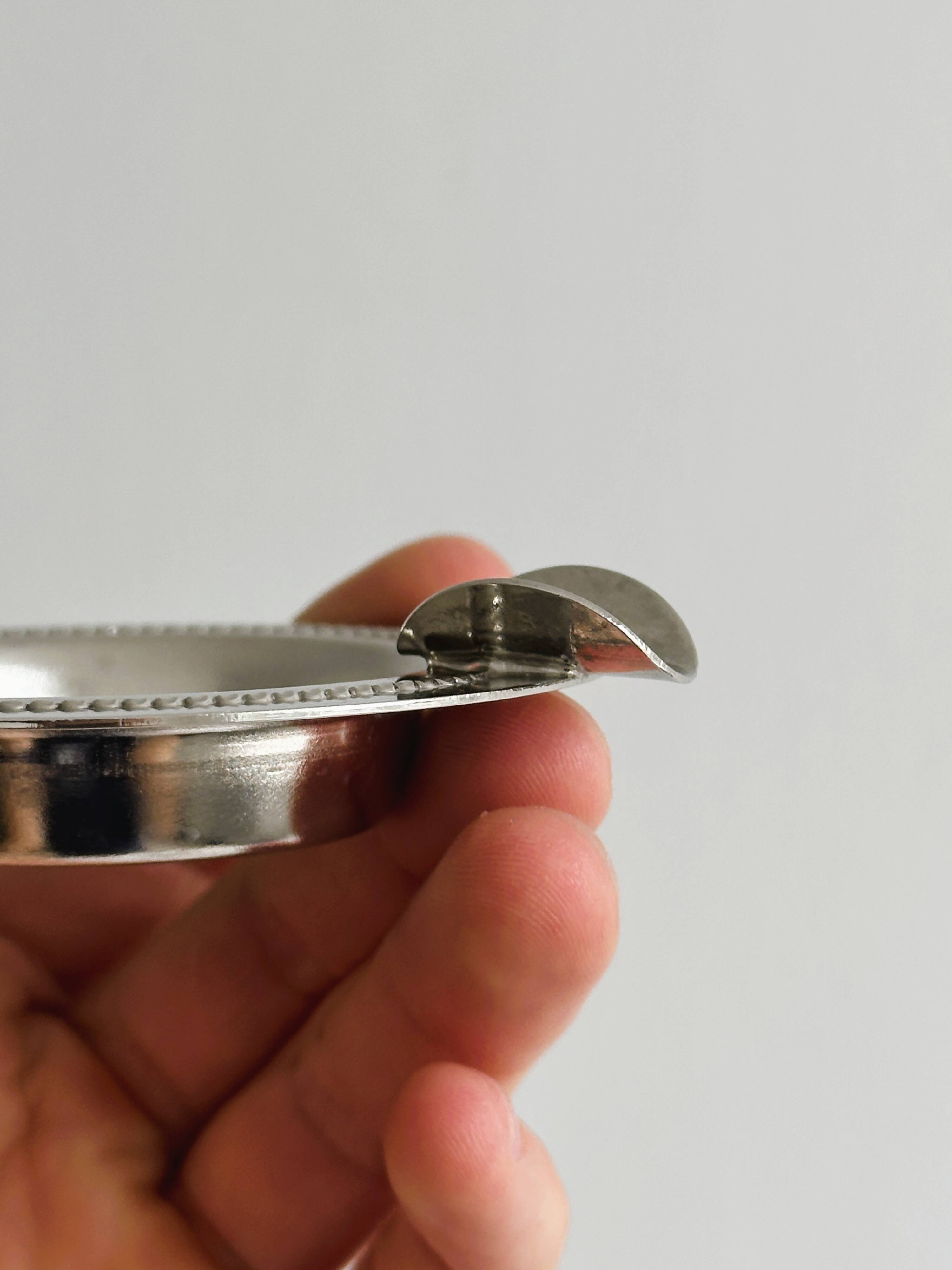 Small ashtray in shiny silver metal