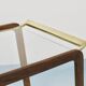 May include: A mid-century modern bar cart with a dark wood frame and two c