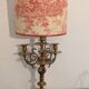 Pair of lamps in gilded brass, red toile de Jouy shades.