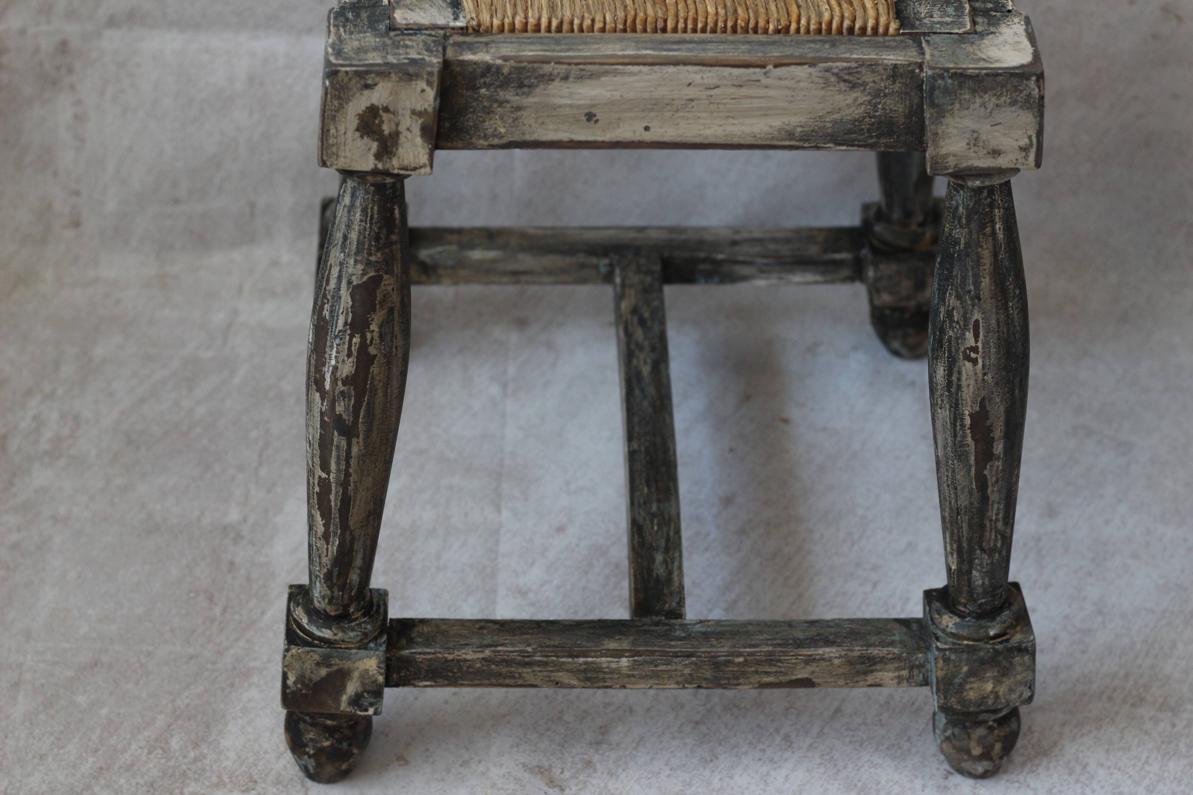 Patinated wooden stool with straw seat