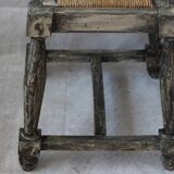 Patinated wooden stool with straw seat