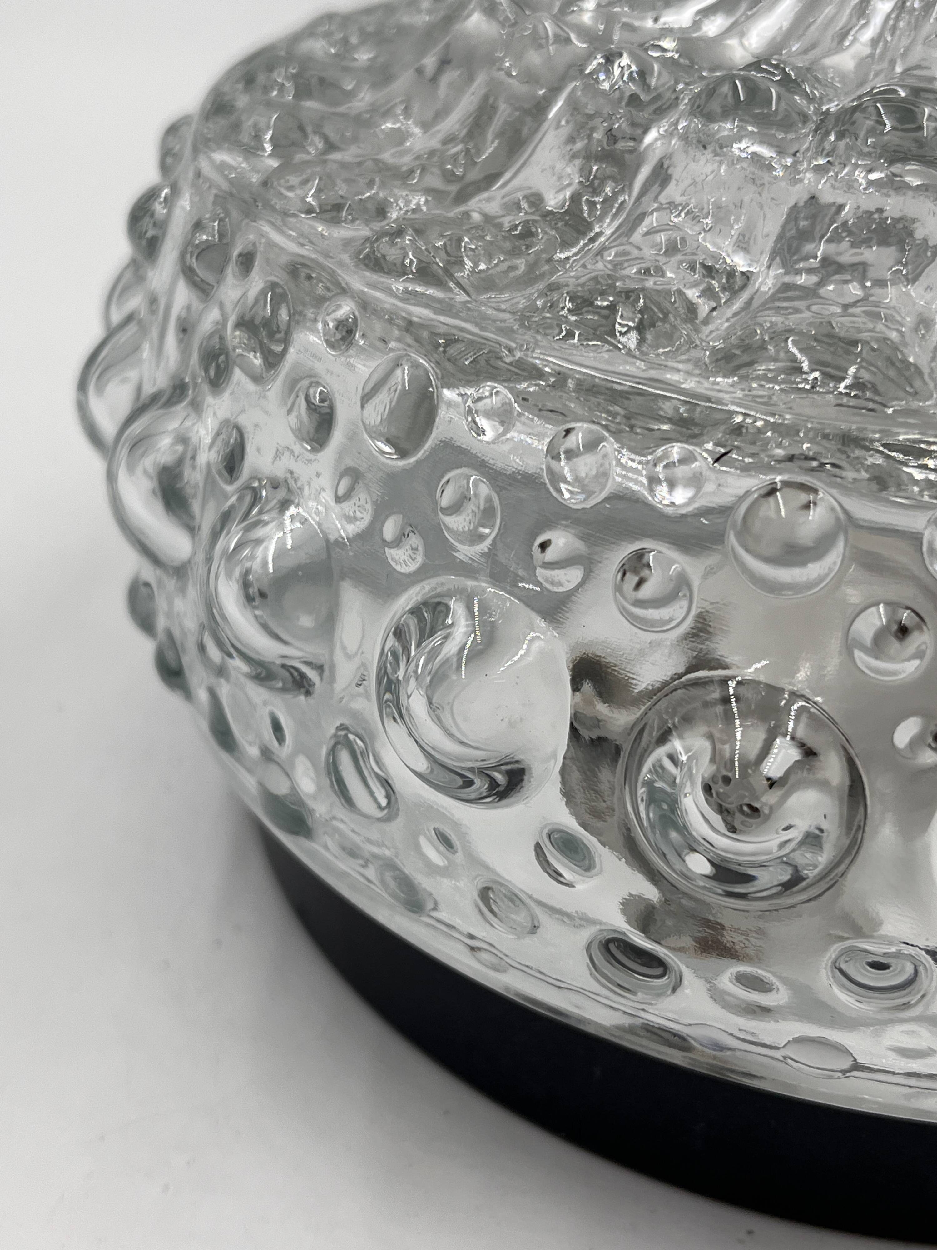 Molded glass ceiling light with spinning top relief