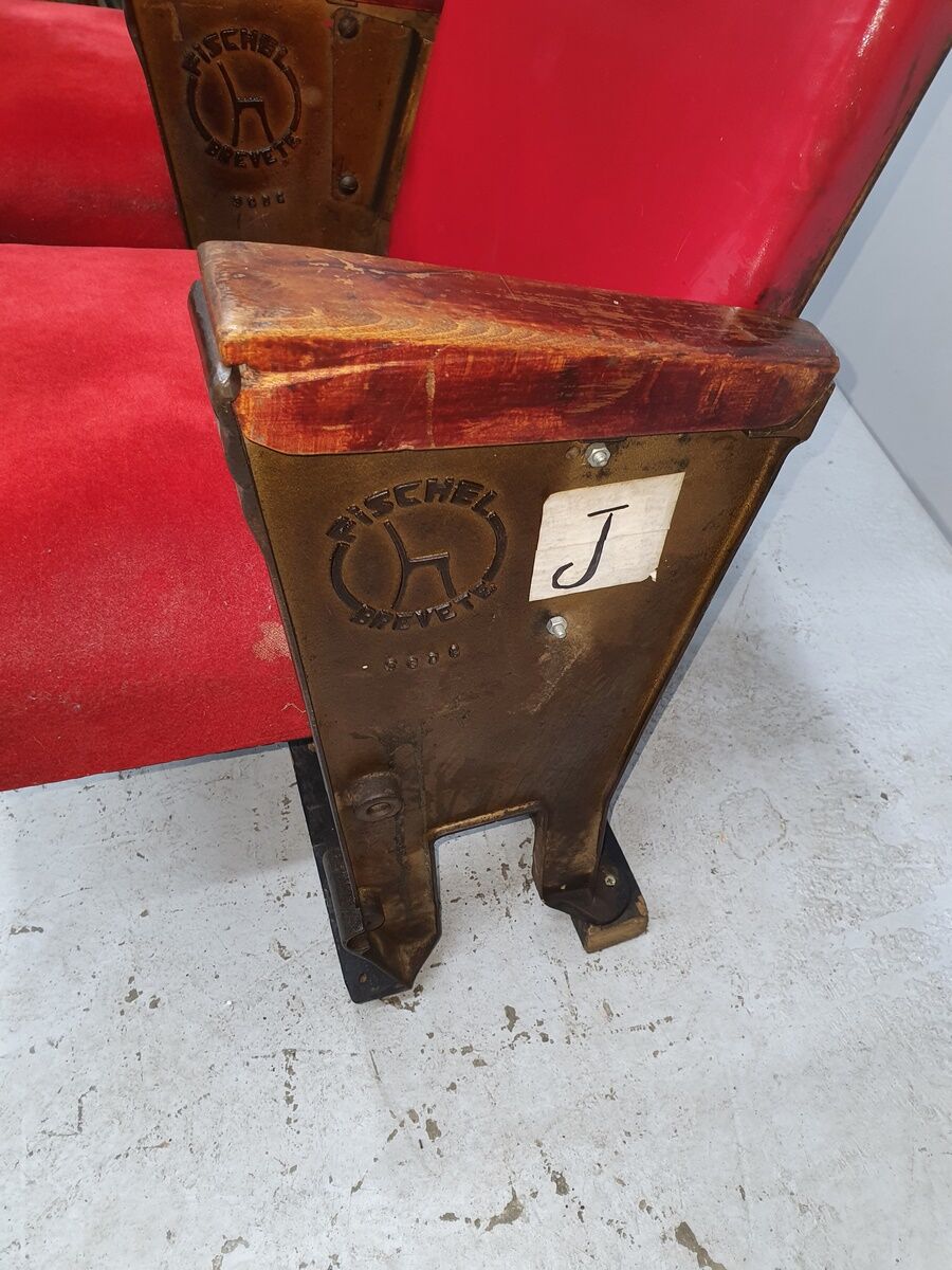 Series of 5 red skai and patinated cast Theater chairs