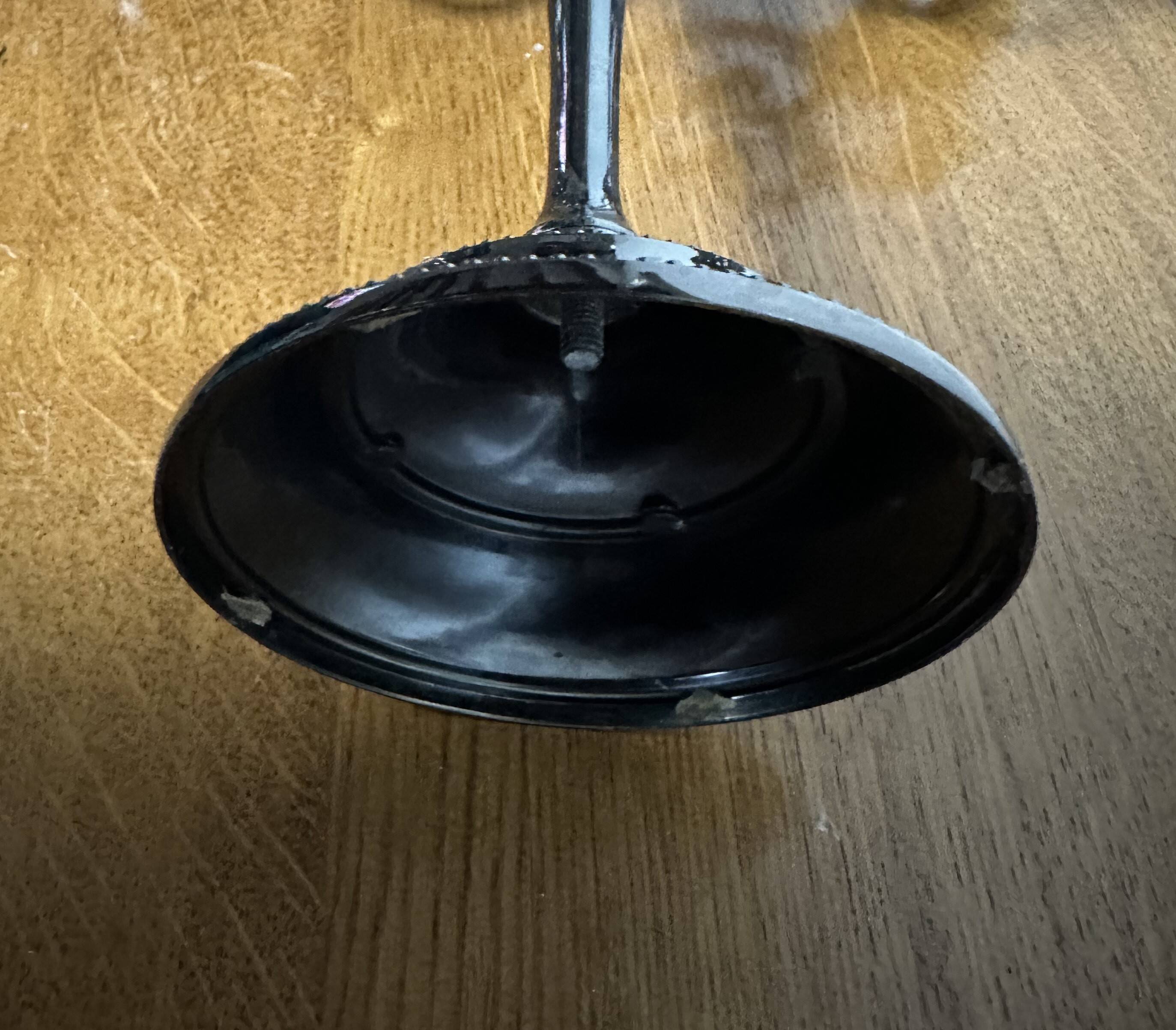 Varnished black metal candlestick