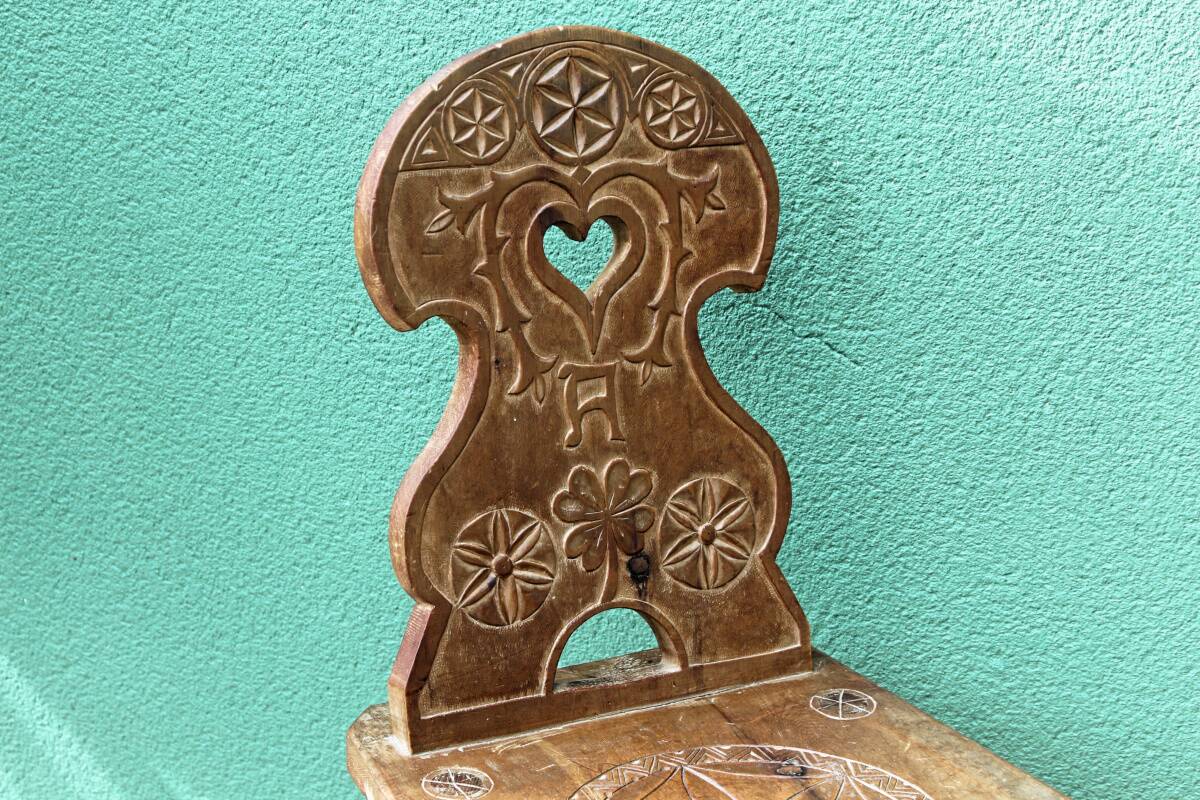 Old Swiss escabelle chair in carved wood