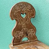 Old Swiss escabelle chair in carved wood
