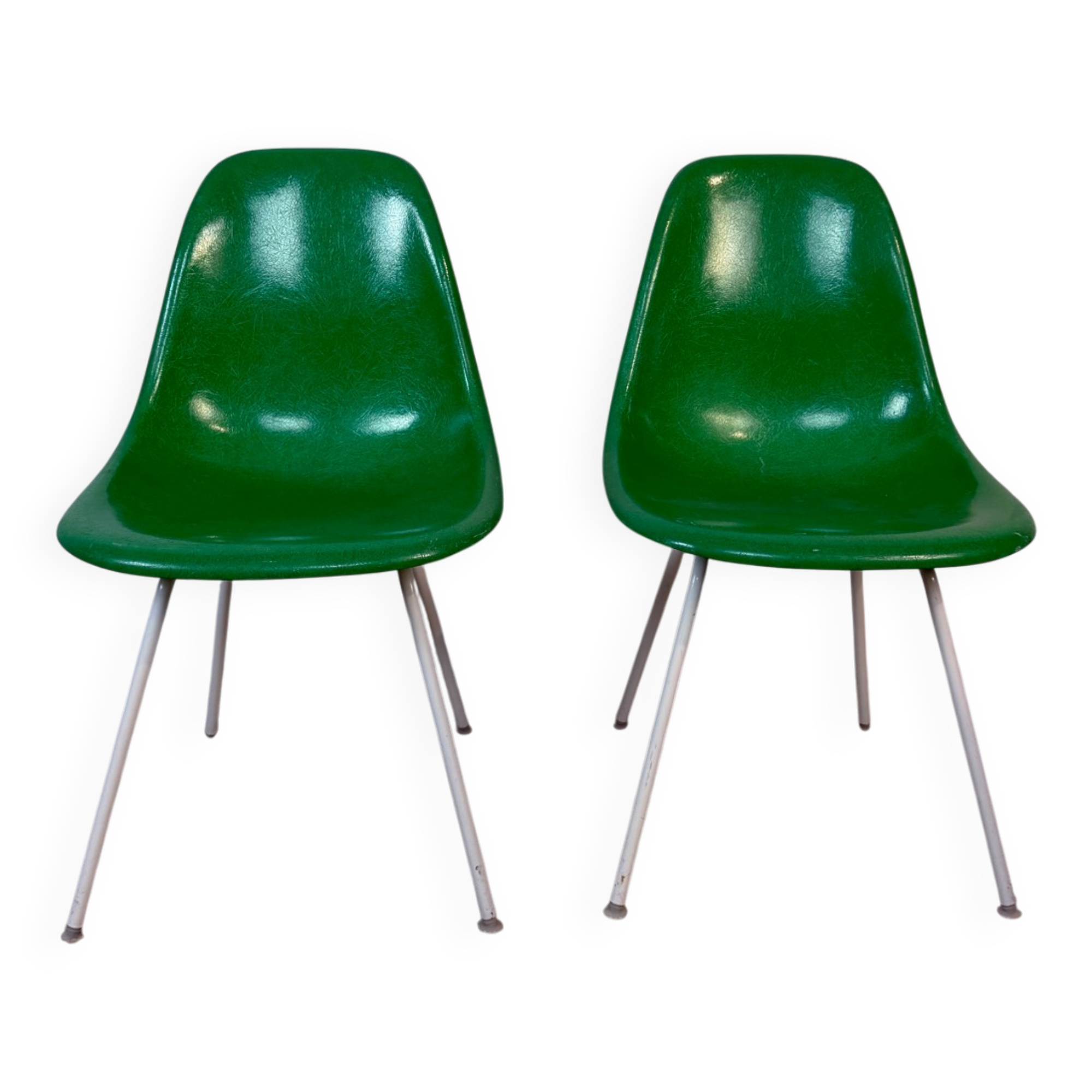Eames Herman Miller chairs in green fiberglass.