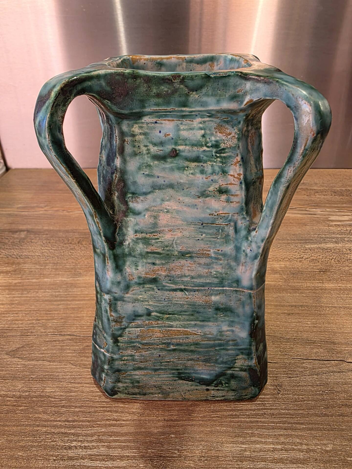 Vintage brutalist ceramic vase with 4 green handles.