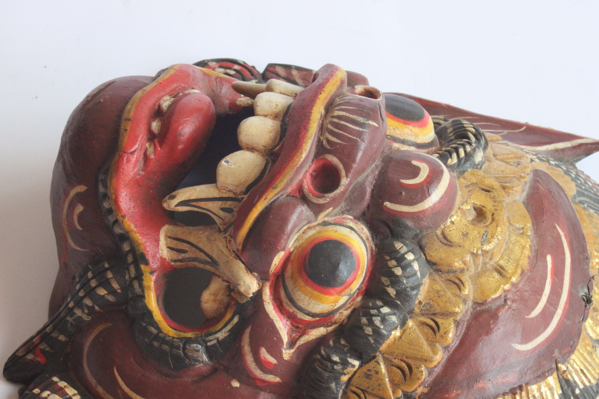Two polychrome painted and gold leaf gilded Barong dance masks from Bali, Indonesia.