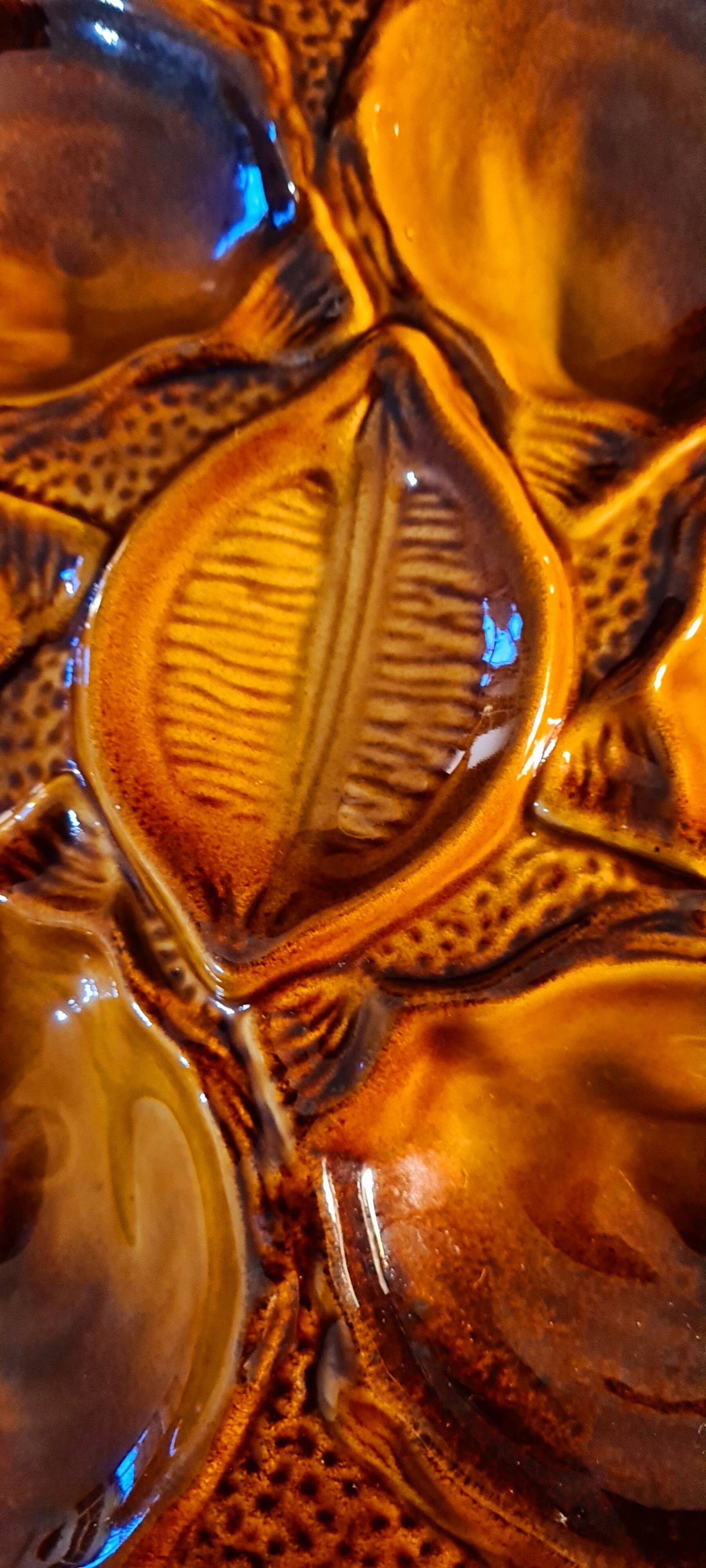 Six oyster plates signed Saint Clément