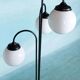 Minimalist floor lamp in glass, space age style.