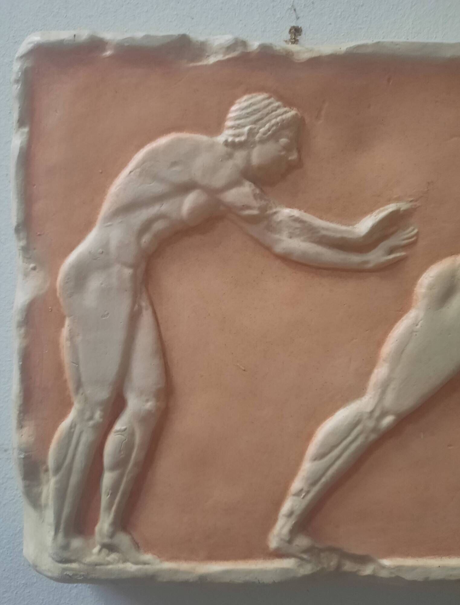 Bas-relief in the antique style featuring athletes.