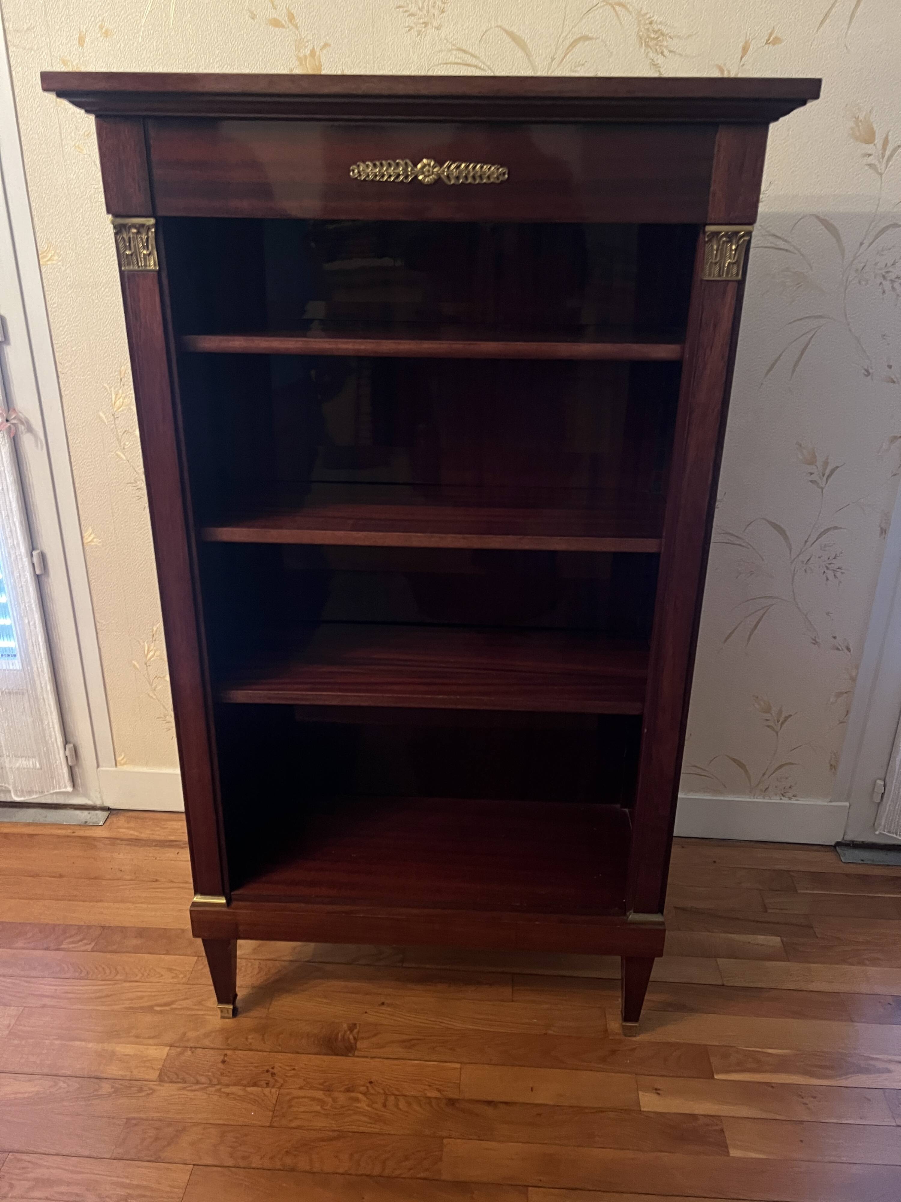 Directoire style bookcase in mahogany, decorated with gilded bronze.
