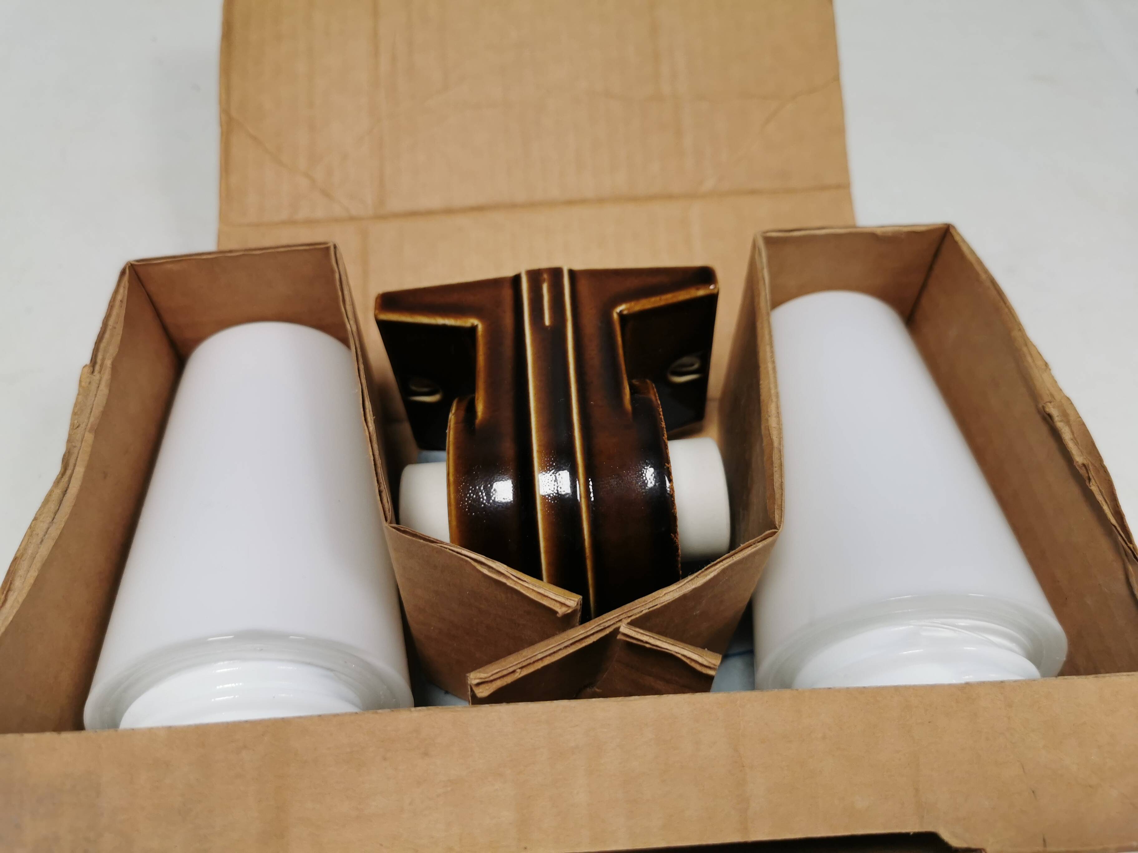 Old bathroom lamp with brown/golden ceramic base, porcelain socket and milky white glass