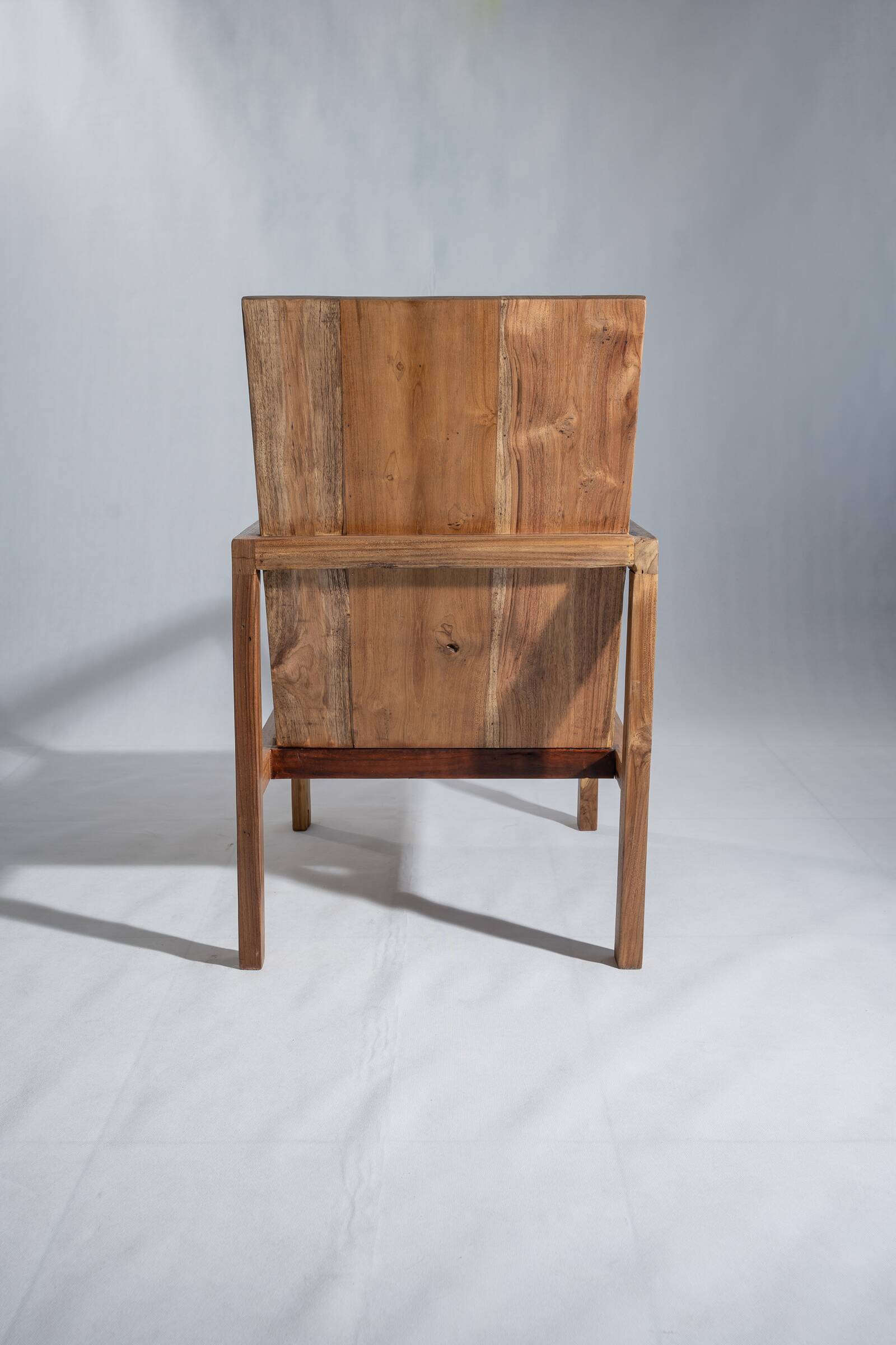 Large armchair in natural wood (teak) with a minimalist design.