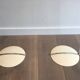 Paire de lampadaires de parquet design composés de bases en métal laqué, chrome et abat-jours design de plastique blancs