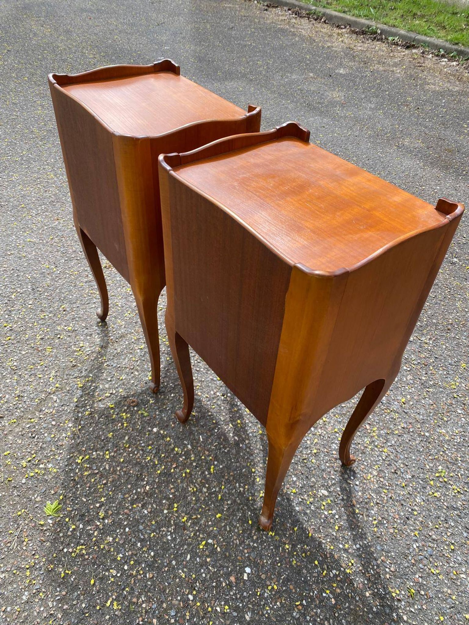 2 Louis XV bedside tables made of curved solid wood with drawers.